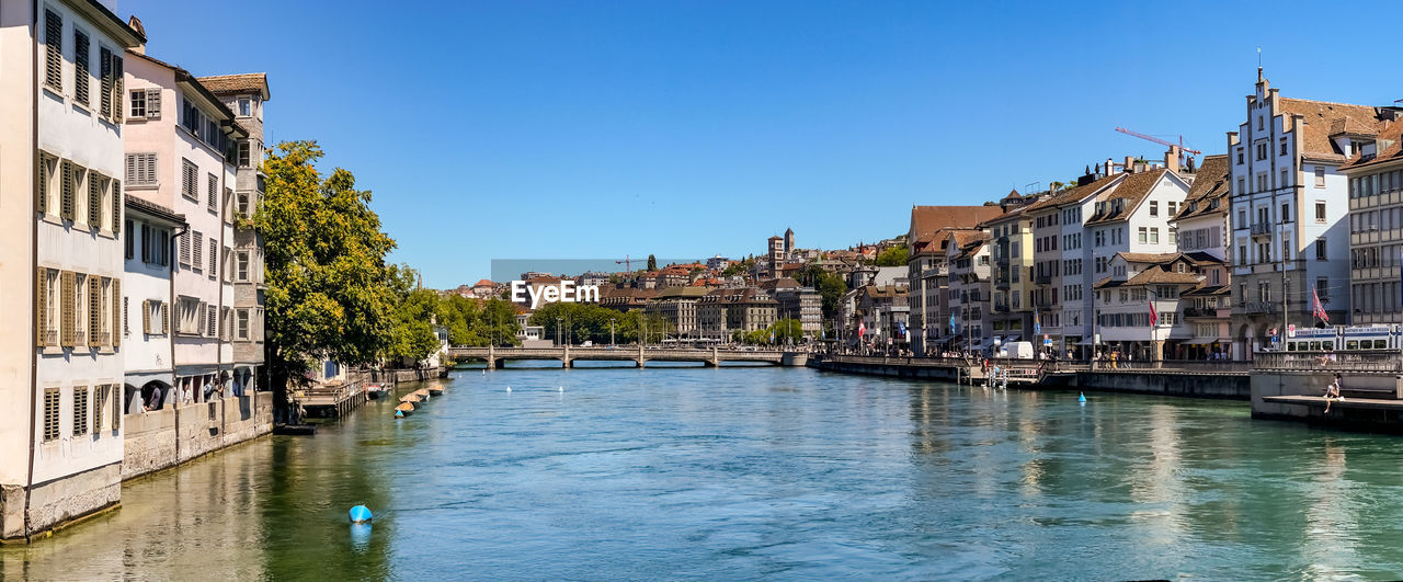 Panoramic view of the limmat river, the rudolf brun bridge and a church 
 in zurich, switzerland