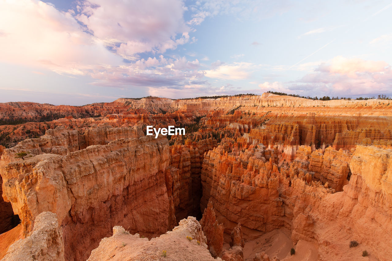 View of rock formations against cloudy sky