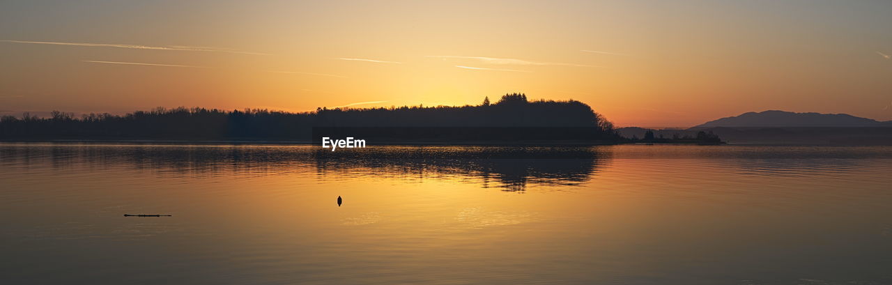 Scenic view of lake against sky during sunrise