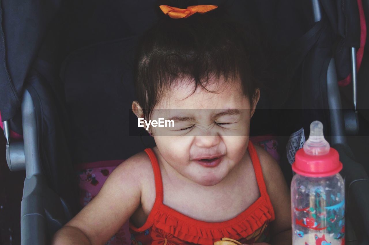 Portrait of baby girl in stroller