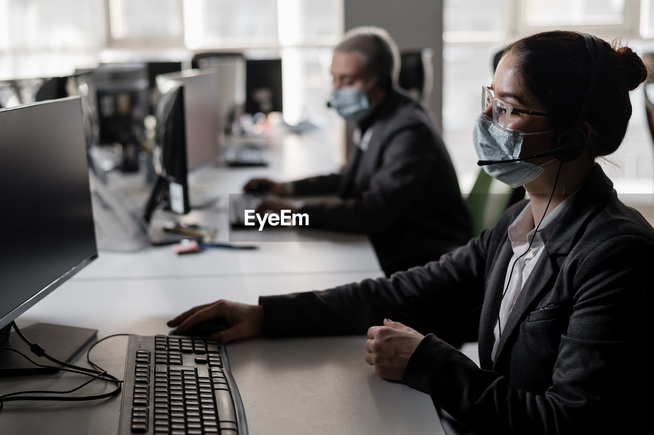 side view of business colleagues working at desk in office