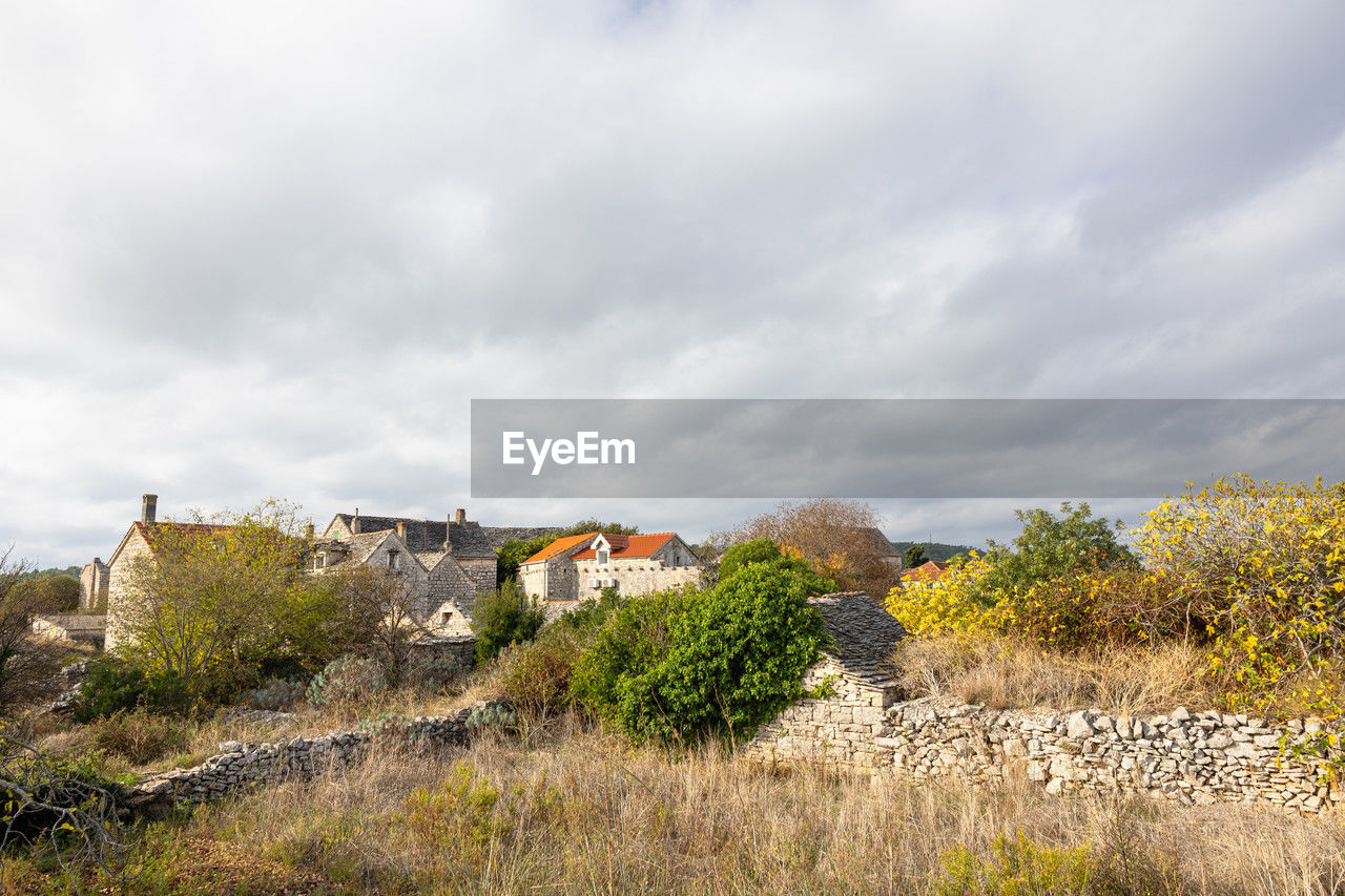 architecture, hill, sky, rural area, building, building exterior, plant, built structure, cloud, landscape, nature, land, house, environment, grass, no people, tree, residential district, flower, travel destinations, history, travel, outdoors, autumn, the past, scenics - nature, beauty in nature, tourism, rural scene, city, sea, coast, village, day, overcast