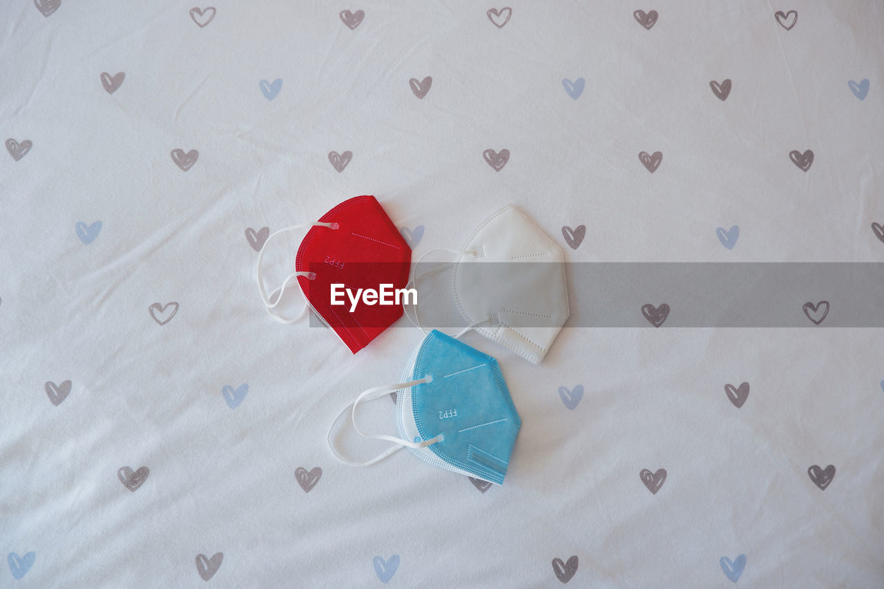 HIGH ANGLE VIEW OF HEART SHAPE MADE ON WHITE PAPER