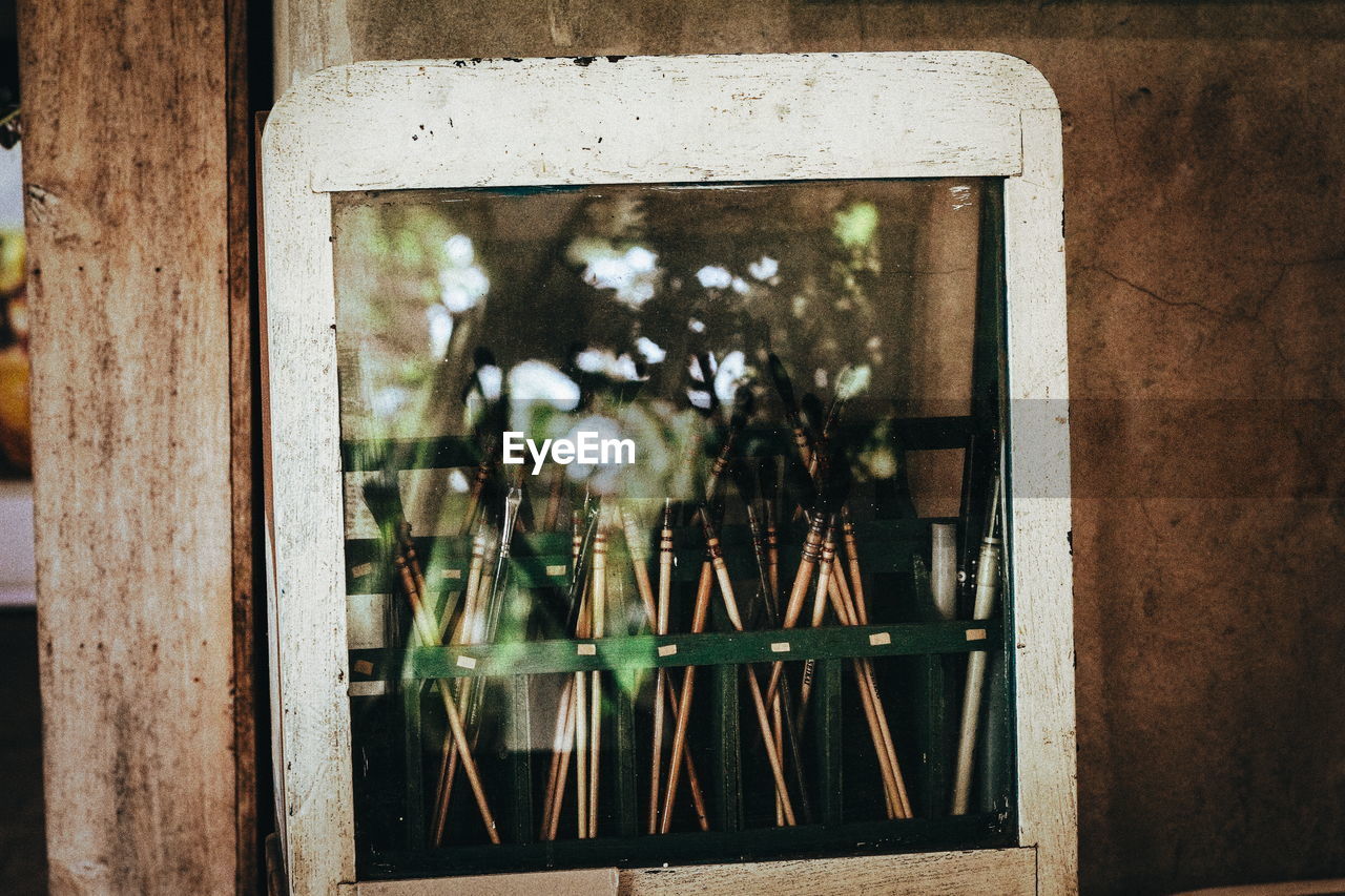 Reflection of paintbrush on window frame