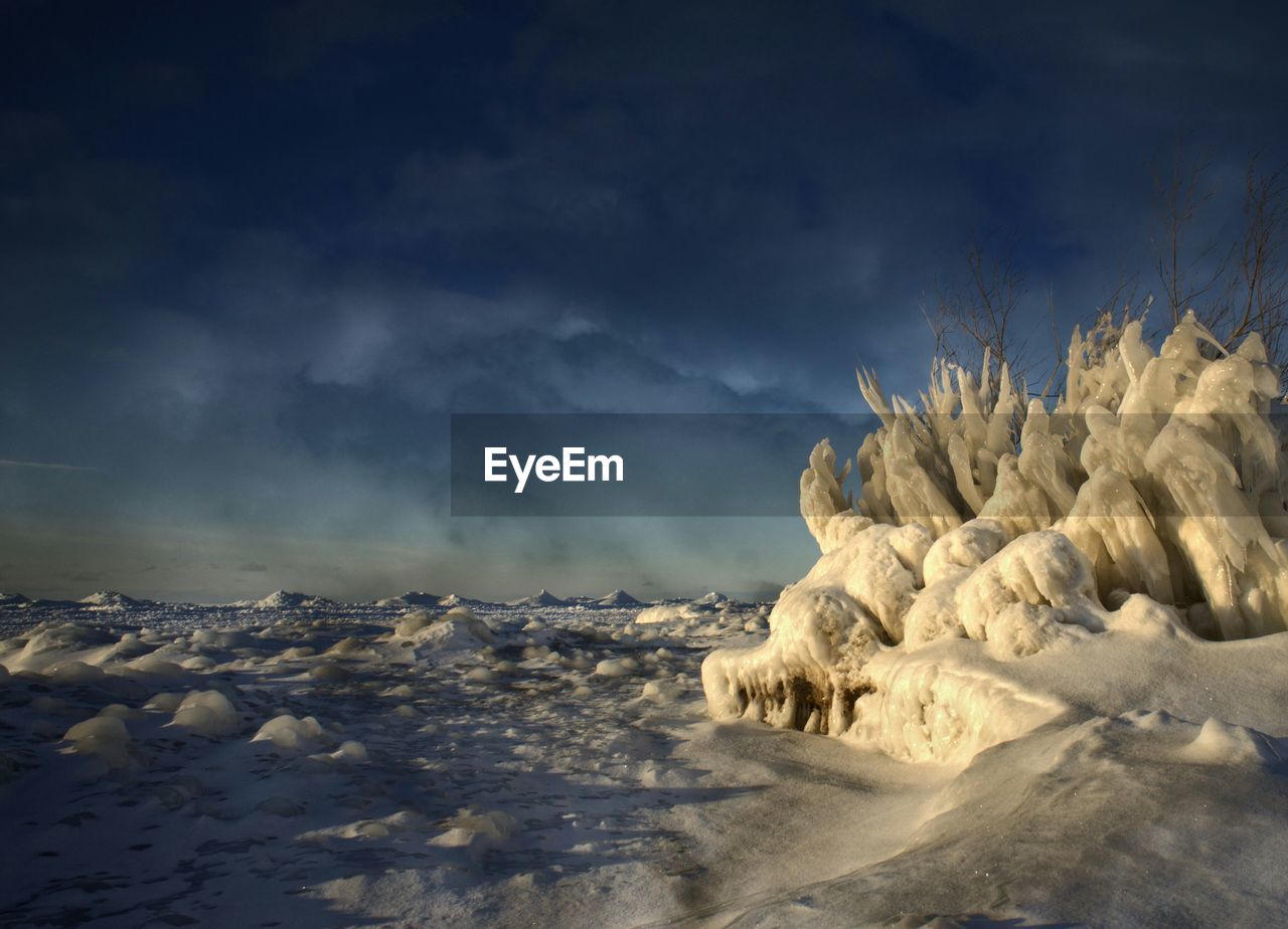 Scenic view of frozen lake michigan against cloudy sky