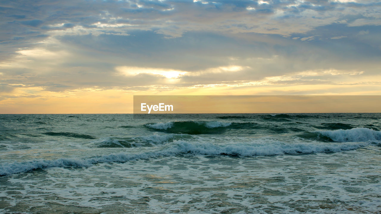 Beautiful sunset on the beach. the surf pounds the shore. phuket, thailand