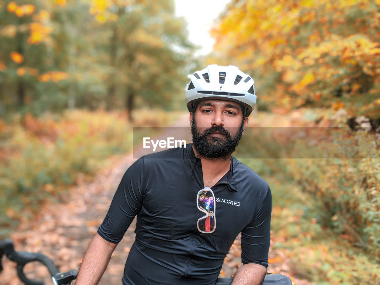 PORTRAIT OF MAN WITH BICYCLE DURING AUTUMN