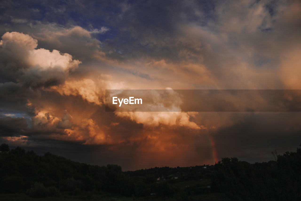 LOW ANGLE VIEW OF SILHOUETTE LANDSCAPE AGAINST DRAMATIC SKY