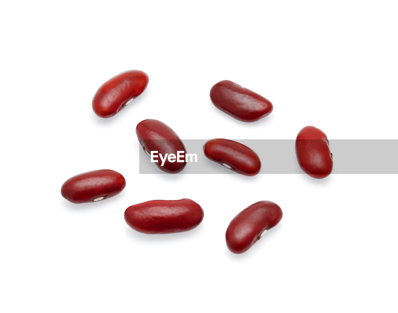 Close-up of maroon beans over white background