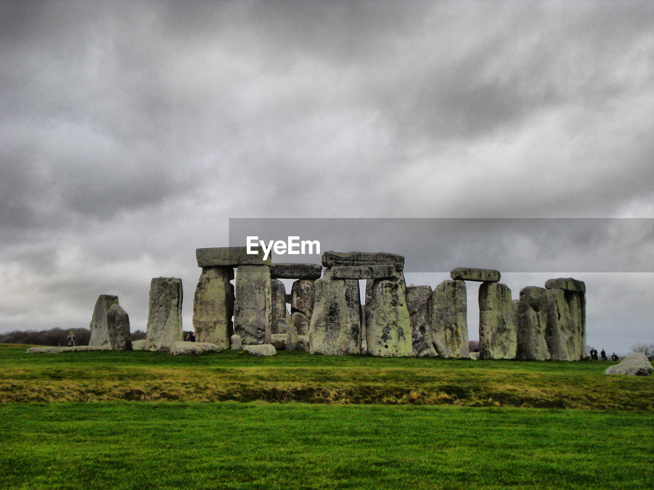 OLD RUIN ON FIELD AGAINST CLOUDY SKY