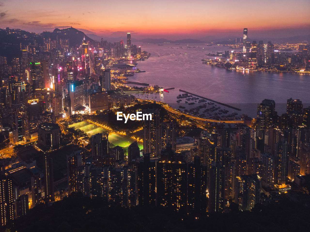 High angle view of illuminated buildings in city at night