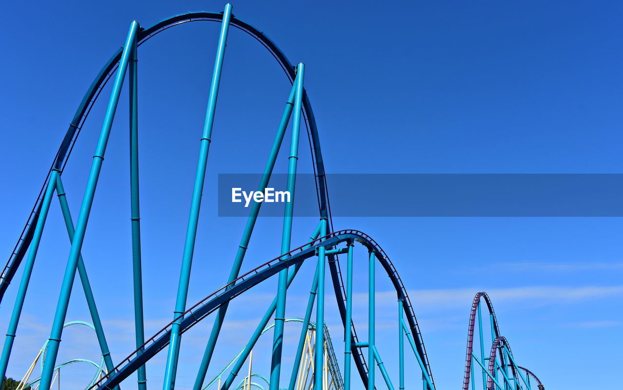 LOW ANGLE VIEW OF ROLLERCOASTER AGAINST SKY