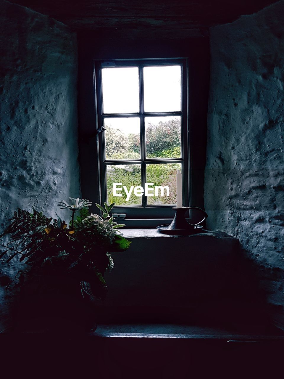 CLOSE-UP OF WINDOW IN ABANDONED ROOM