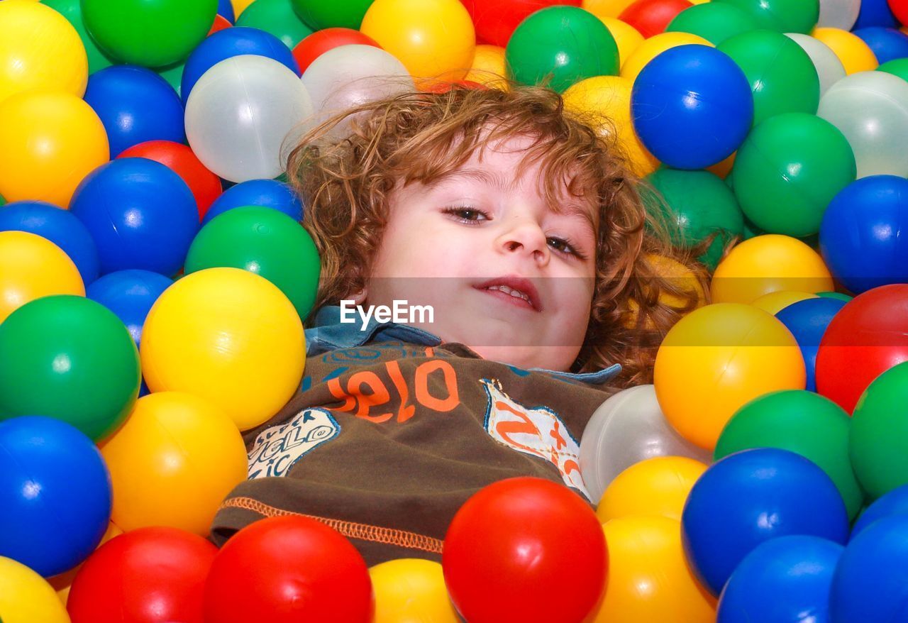 Portrait of boy with ball in balloons