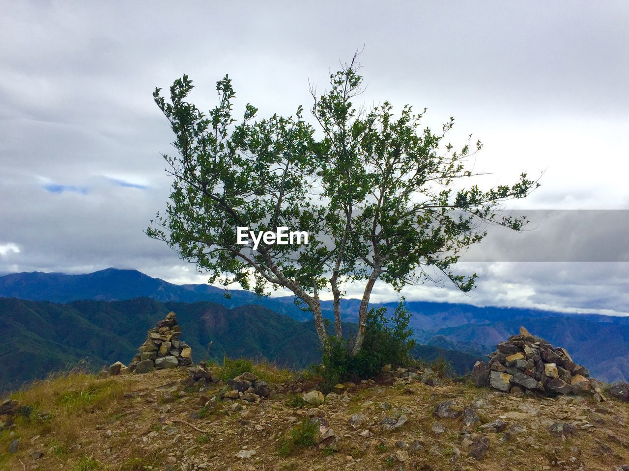 Scenic view of mountain against cloudy sky