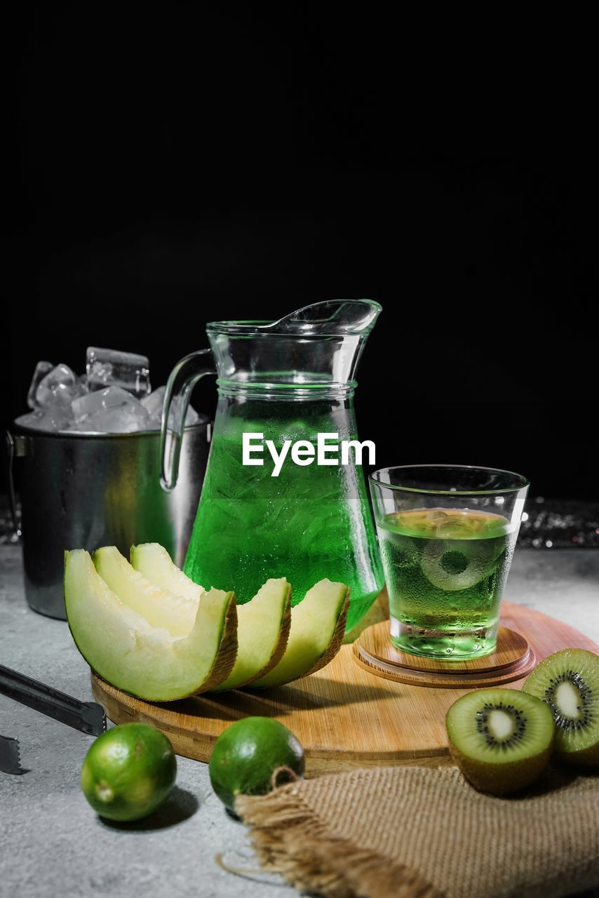 Close-up of food and drink on table against black background