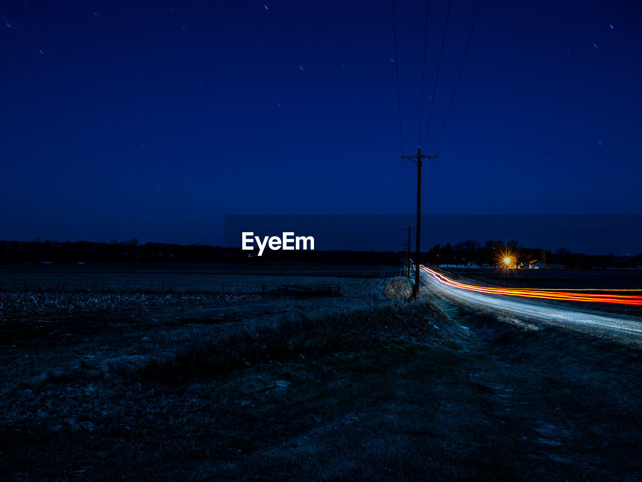 Light trails by land on road at night