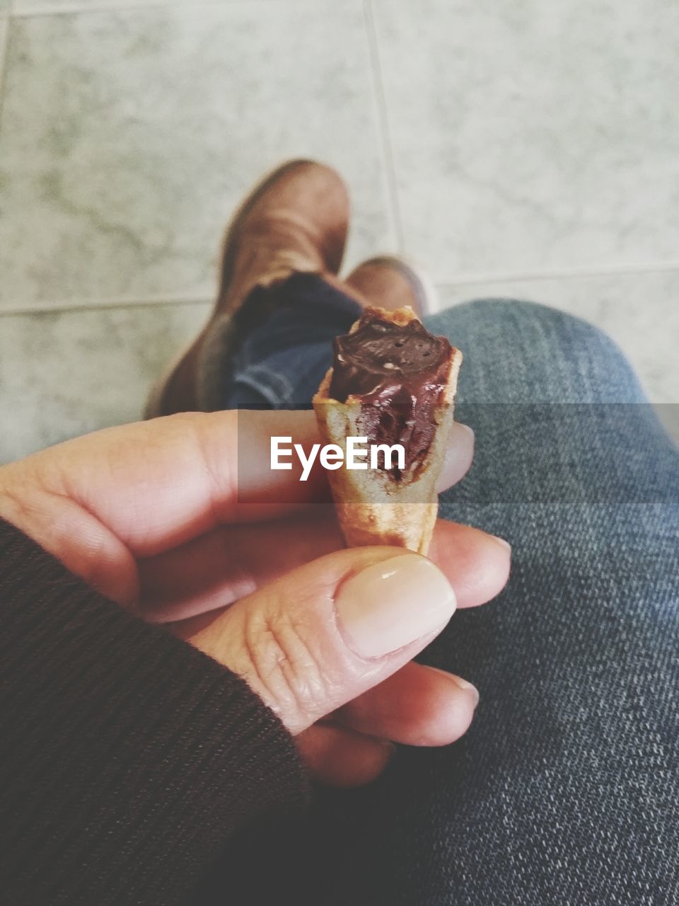 Low section of person holding ice cream cone