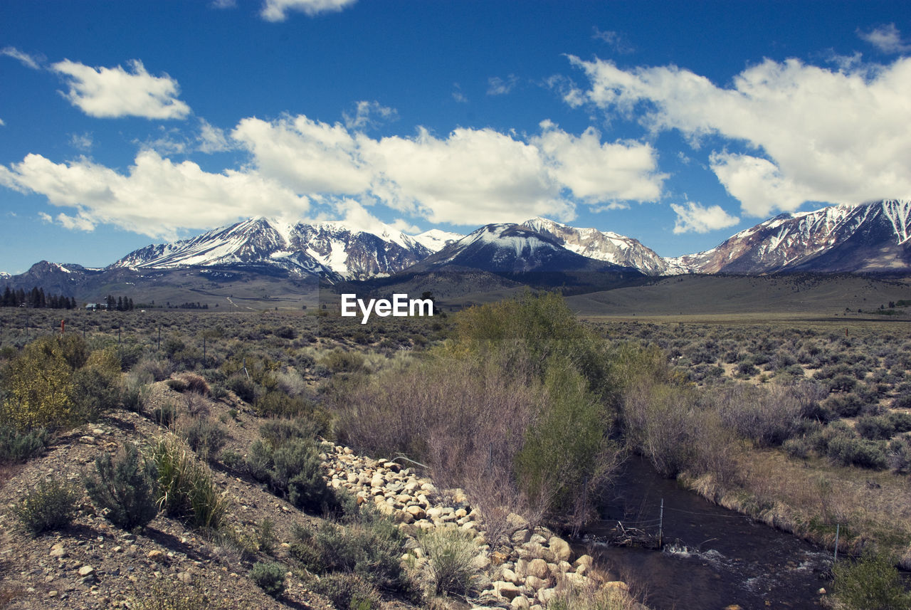 Scenic view of snowcapped mountains against cloudy sky