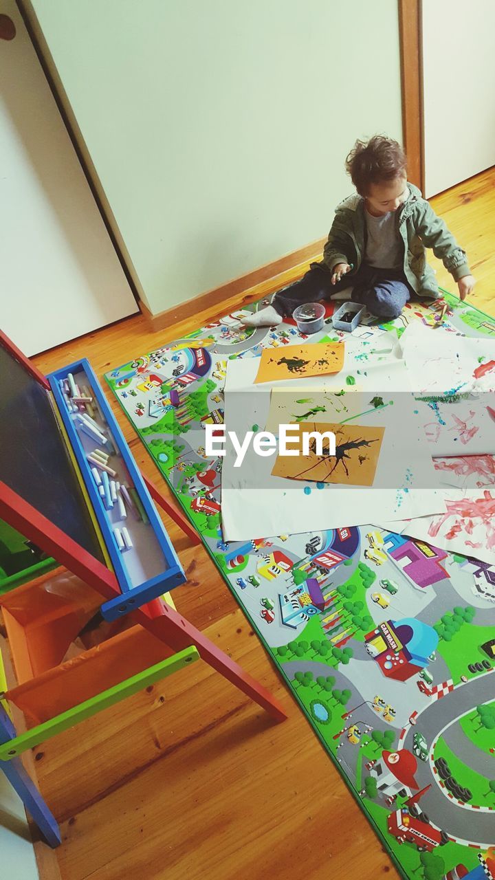 High angle view of boy painting at home