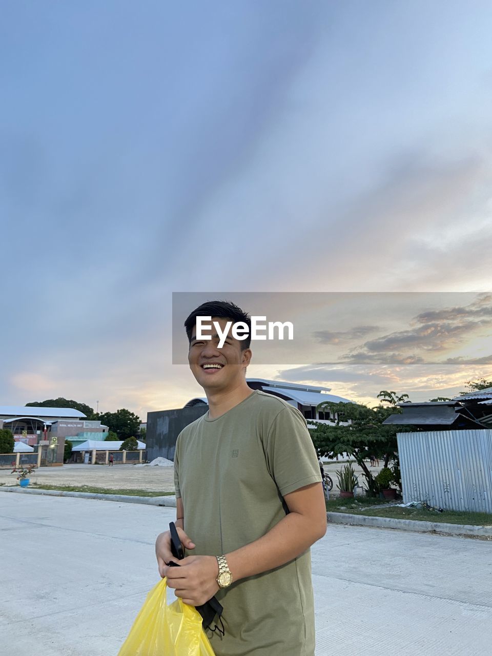 Low angle view of young man standing against sky