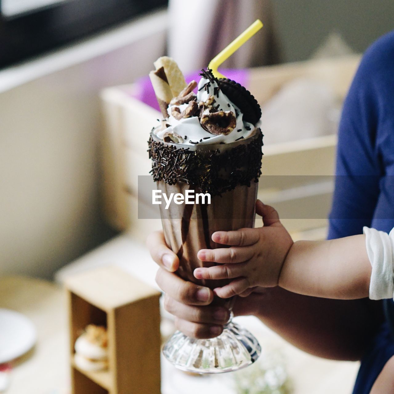 Cropped mother and child holding milkshake