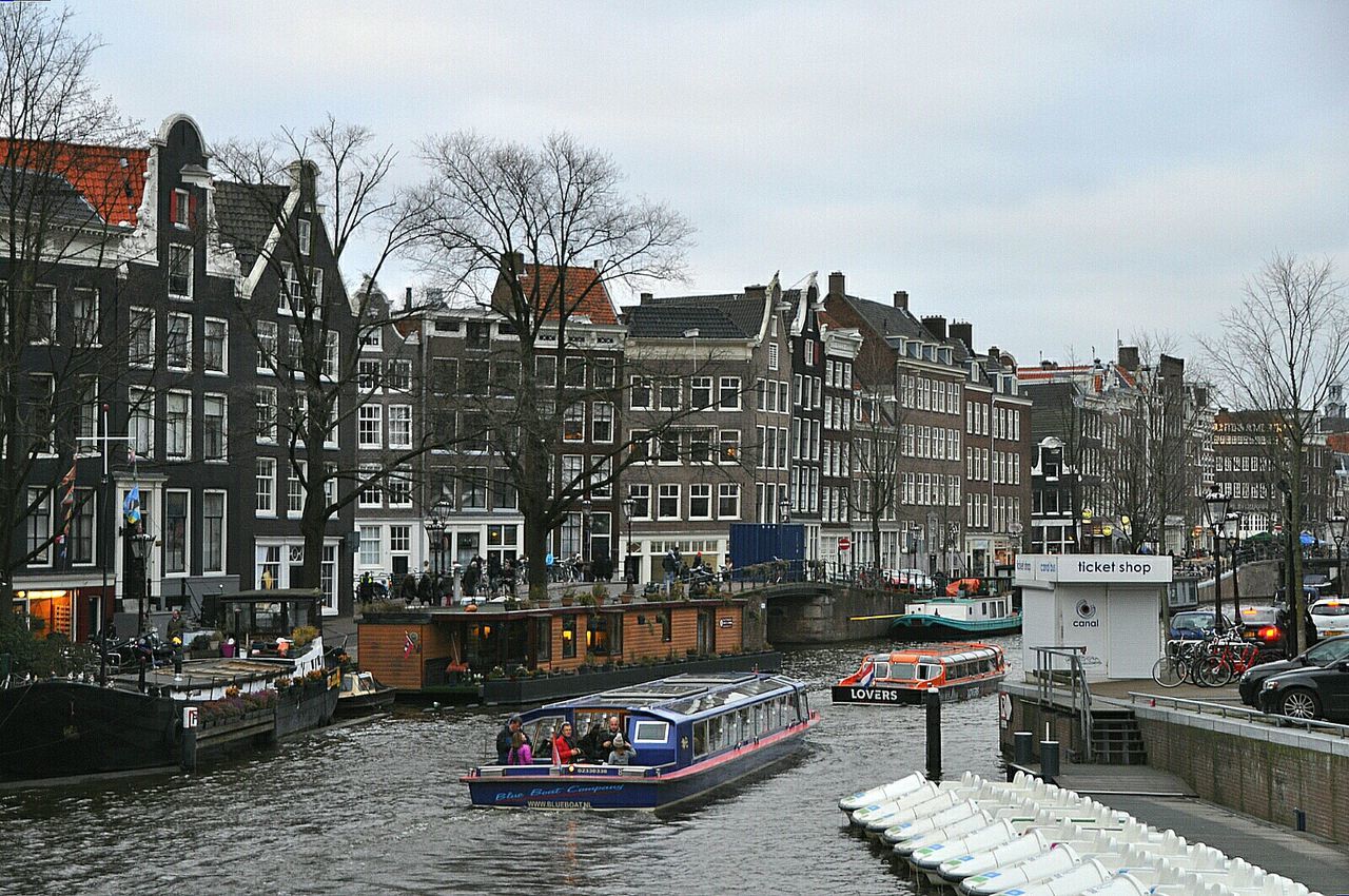 High angle view of boats on canal against buildings in city