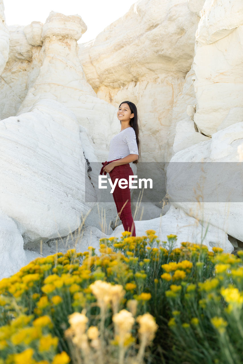 Portrait of girl standing on rock