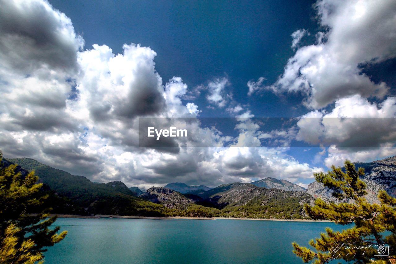 Scenic view of calm lake against mountain range