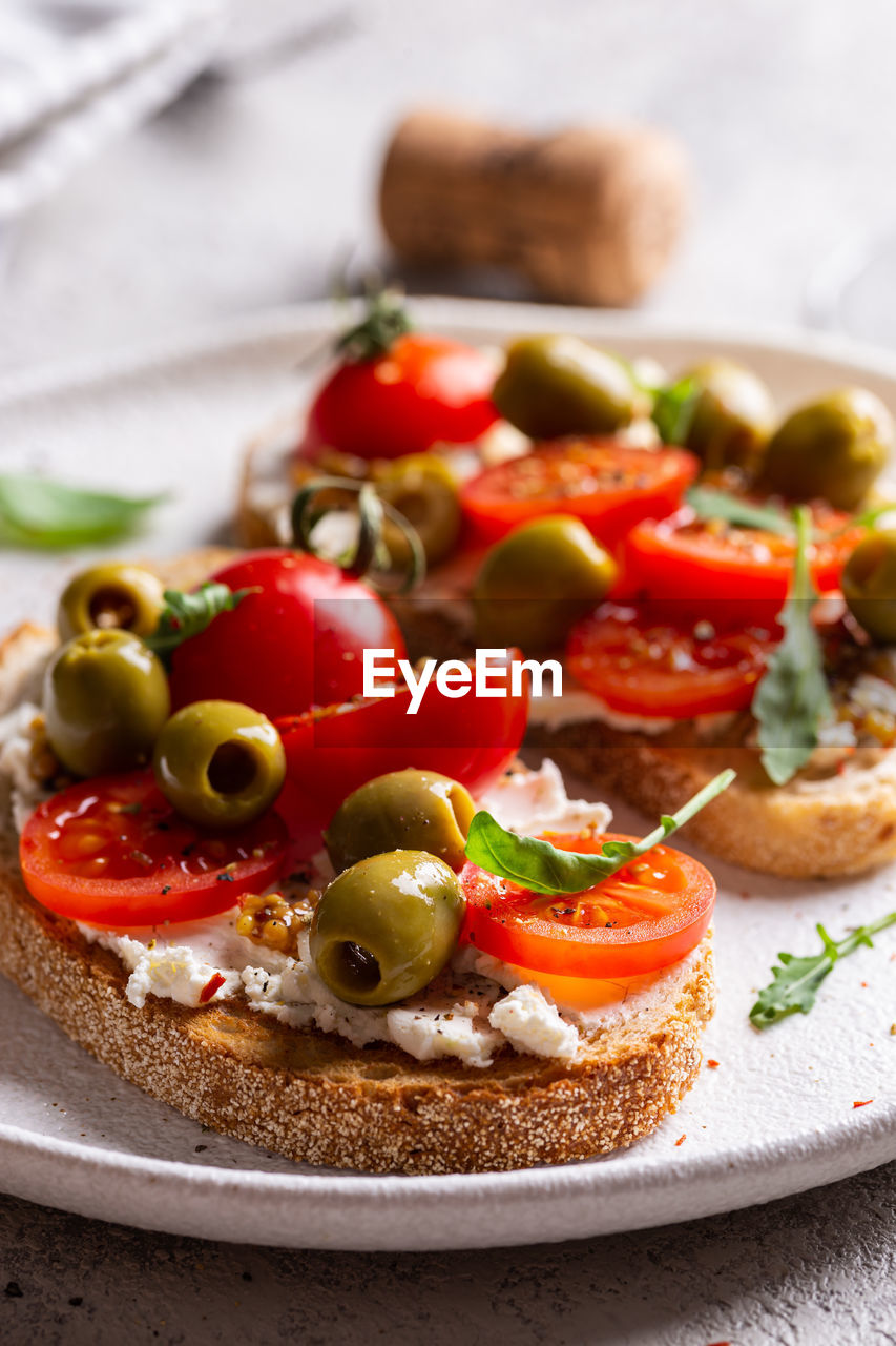 Plate with bruschettas and glass of wine