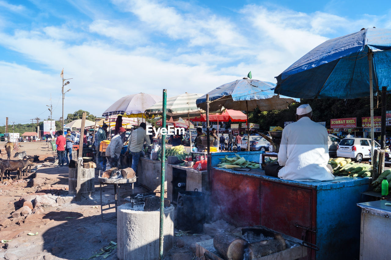 PEOPLE AT MARKET STALL