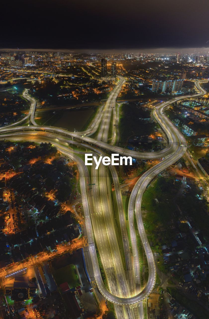 High angle view of illuminated city buildings at night