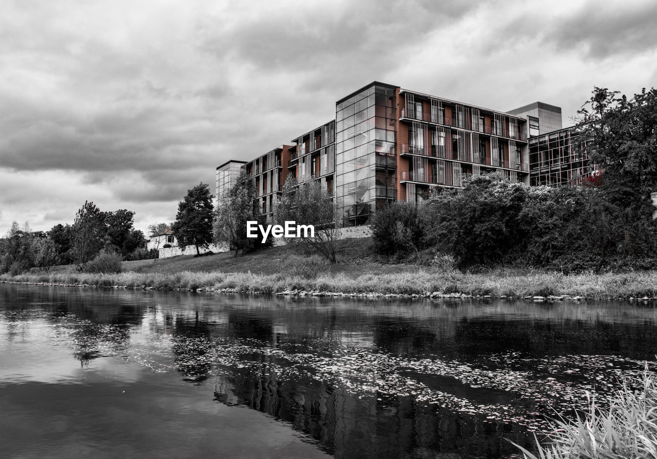 LAKE BY BUILDING AGAINST SKY