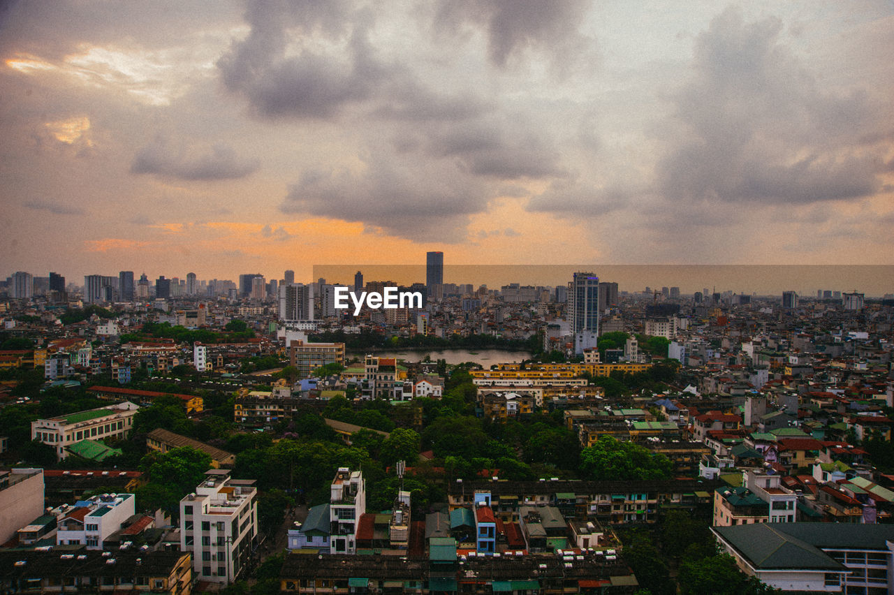 Aerial view of buildings in city against sky