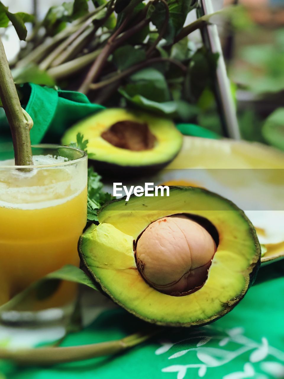 Close-up of juice and avocado on table