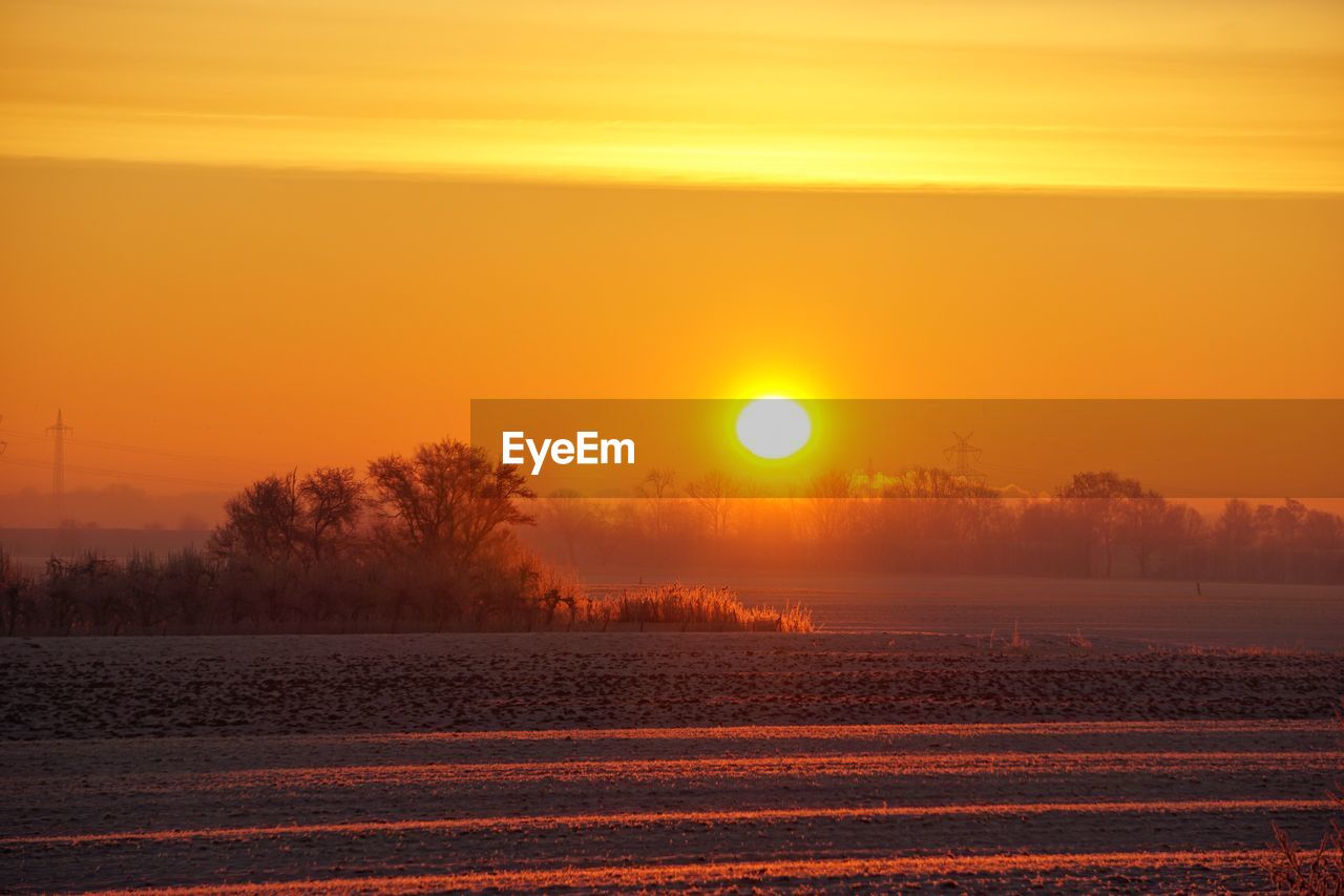 Scenic view of sunset over land