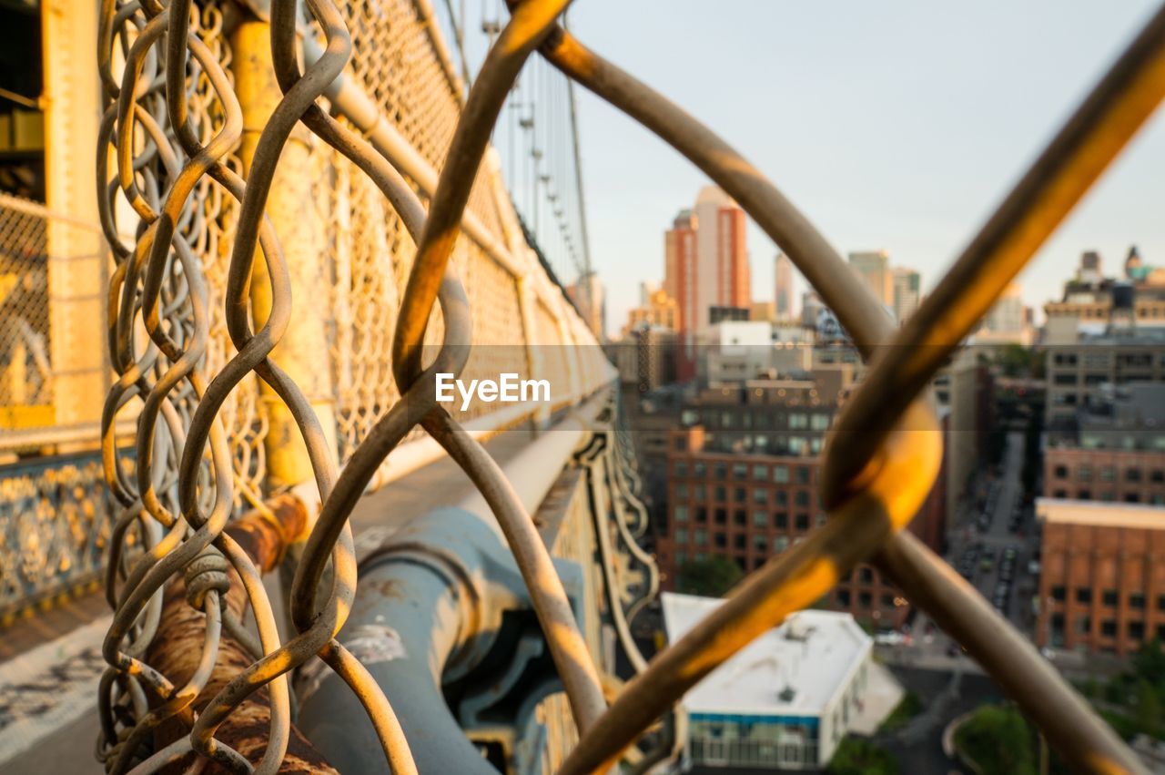 Buildings seen through manhattan bridge in city