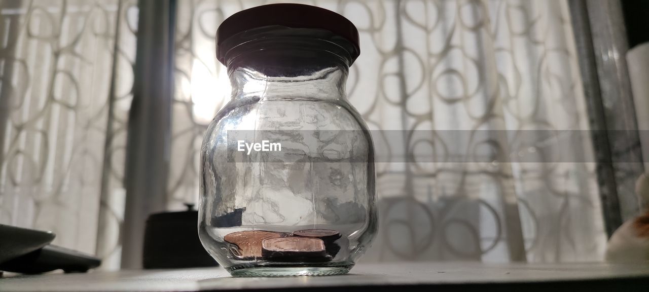 Close-up of glass jar on table at home