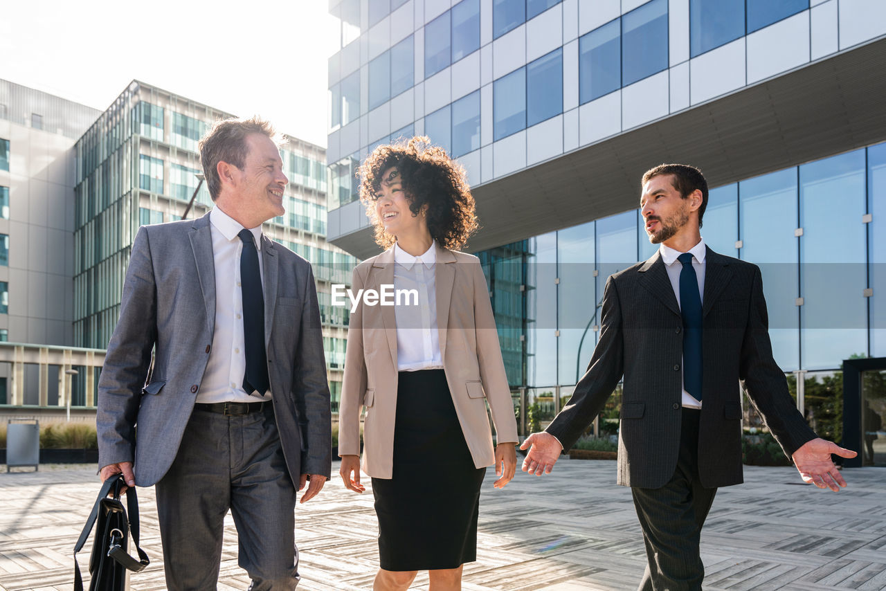 business colleagues standing against building