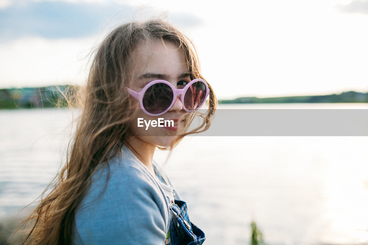 Portrait of girl wearing sunglasses against sky