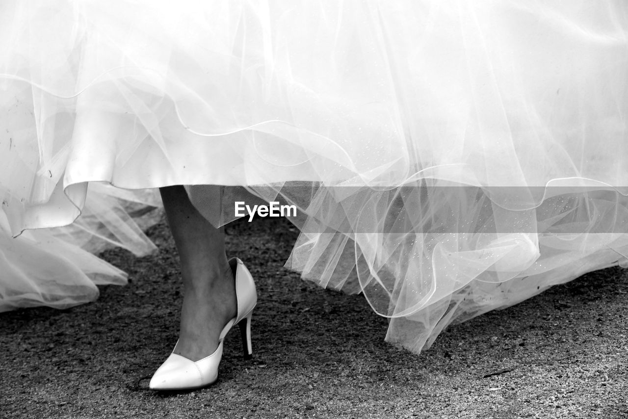 Low section of bride wearing high heels