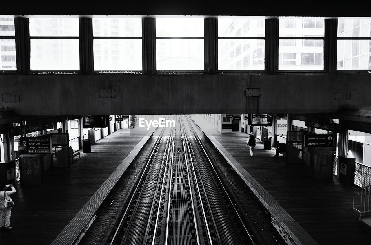 RAILROAD TRACKS IN ILLUMINATED UNDERGROUND STATION