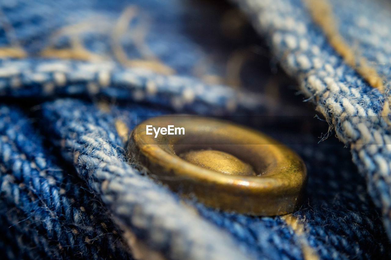 Macro shot of copper button on jeans