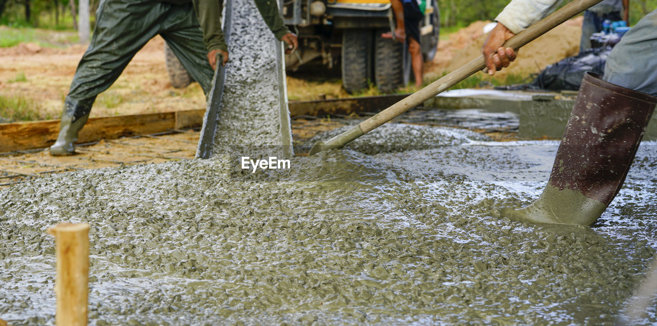 Construction worker pour wet concrete at construction site. construction worker working 