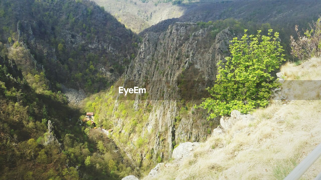 HIGH ANGLE VIEW OF WATERFALL ON MOUNTAIN