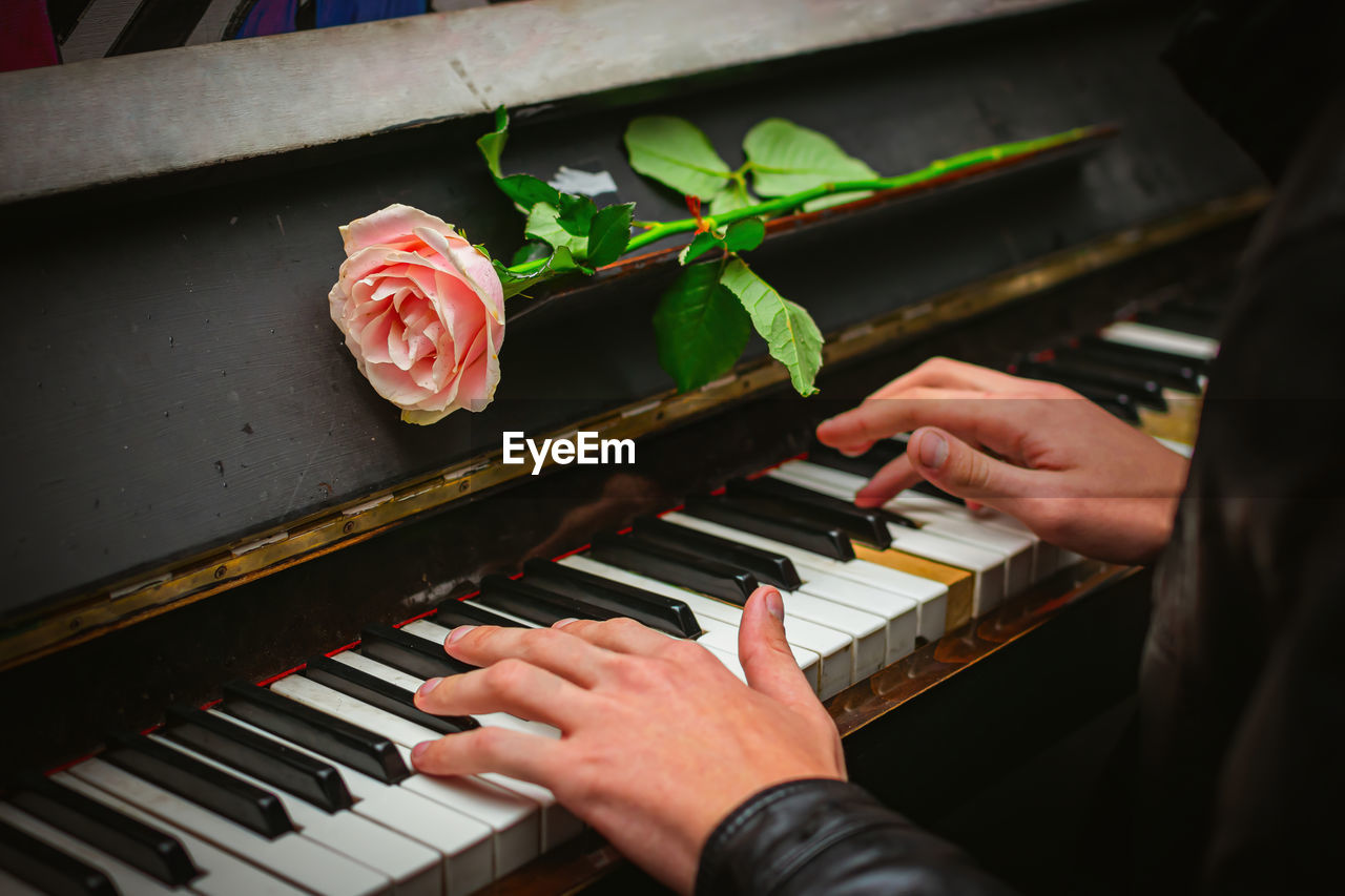 The hands of a street musician playing the piano