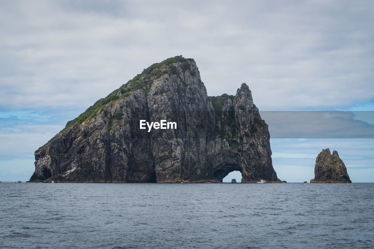 ROCK FORMATIONS IN SEA AGAINST SKY