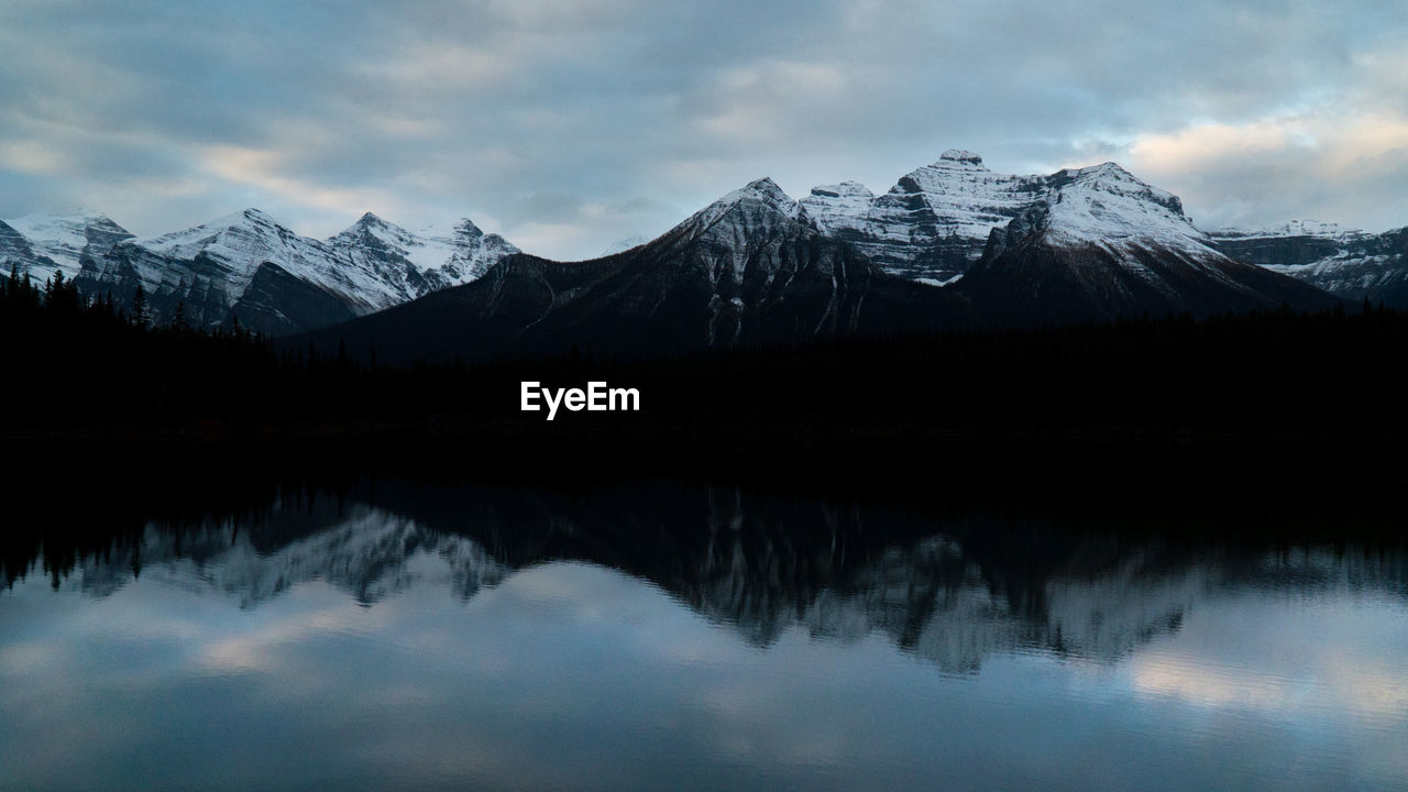 Scenic view of lake and snowcapped mountains against sky