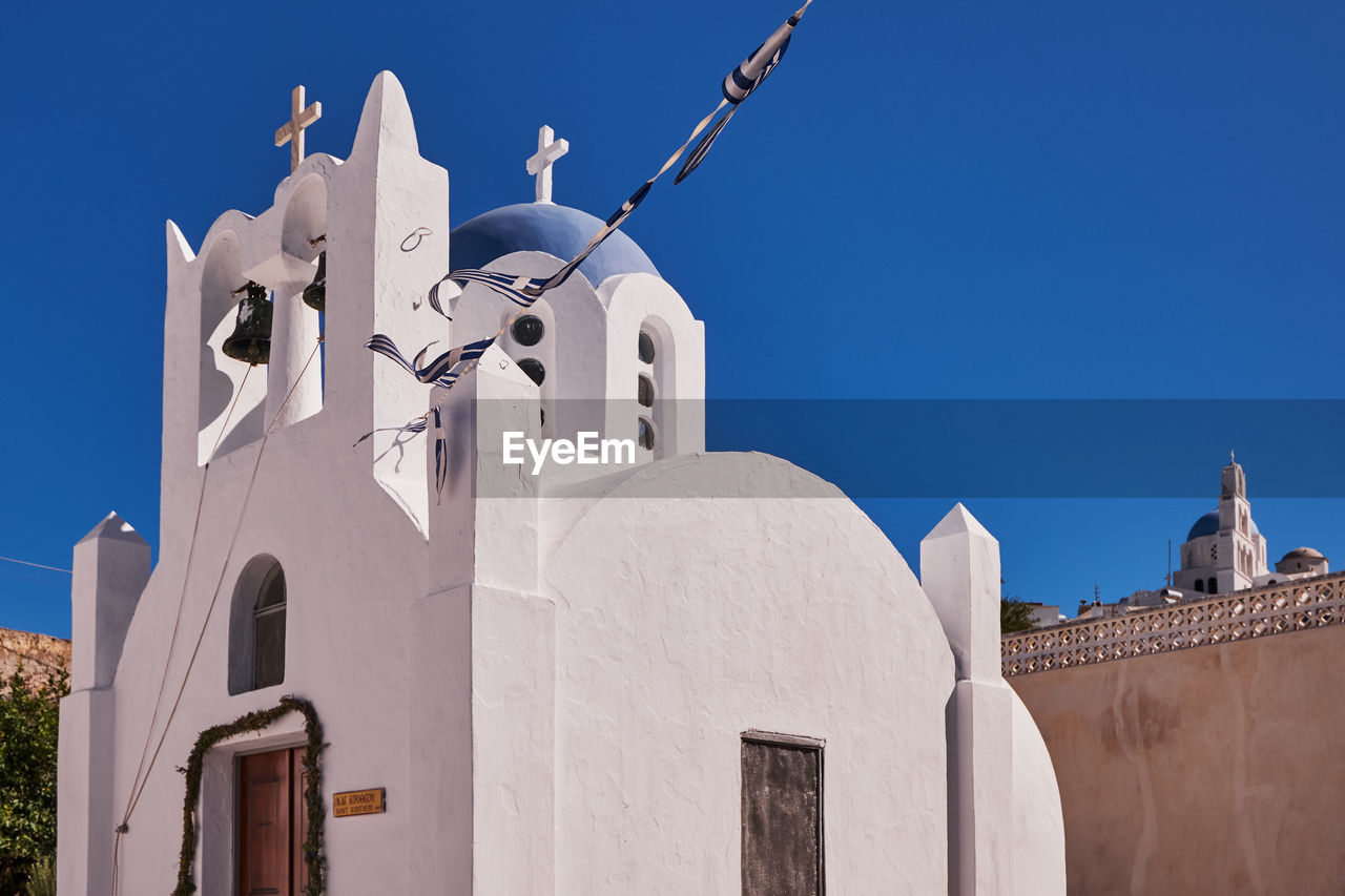 Saint ierotheos holy chapel - blue dome and bell tower - pyrgos village, santorini island, greece