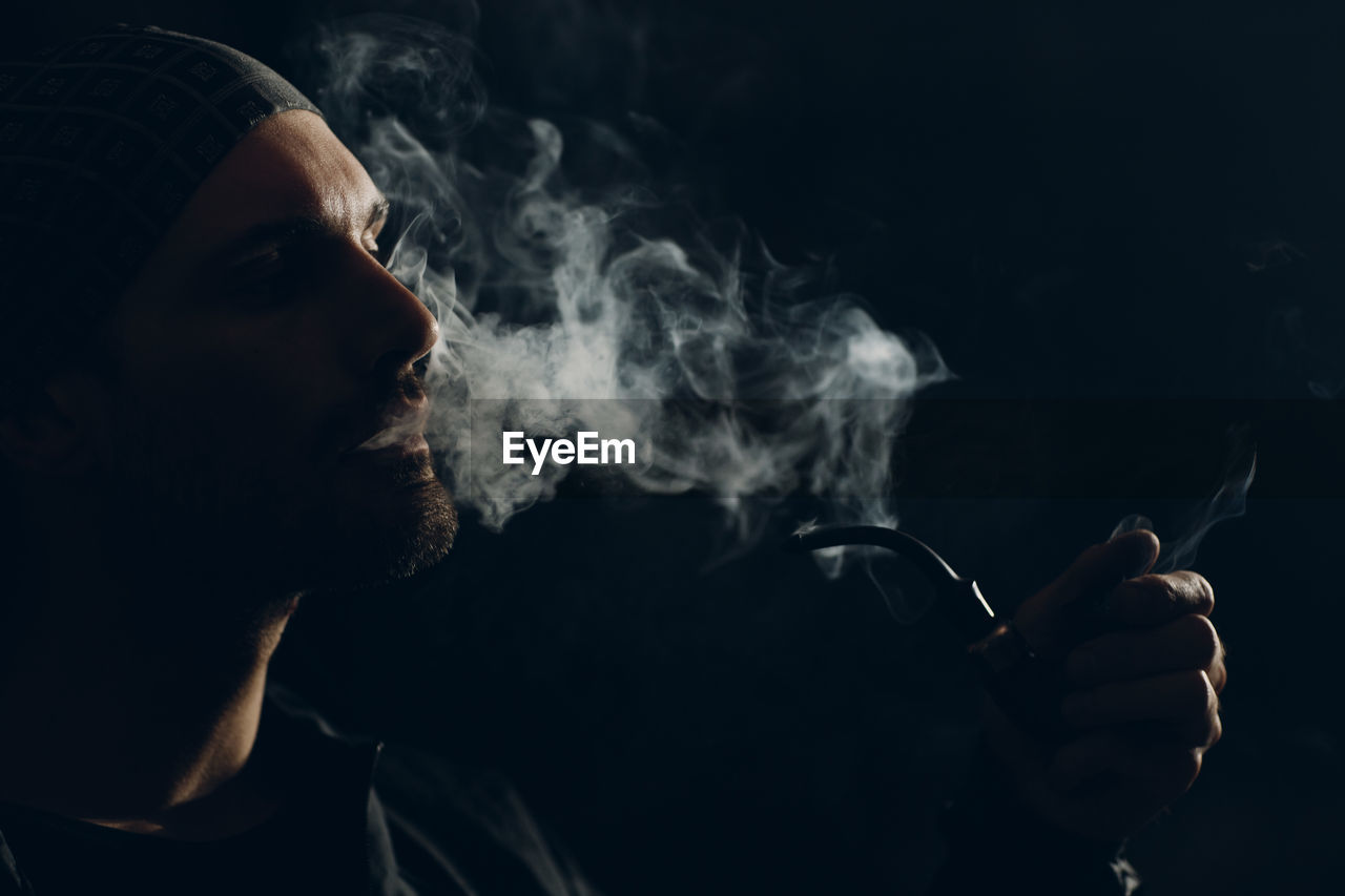 Portrait of man smoking cigarette